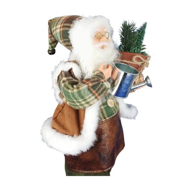 Père Noël en jardinier de profil tenant pot de sapin dans le bras droit et un arrosoir dans la main gauche.