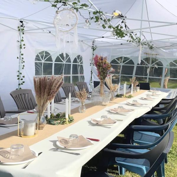 Tonnelle pliable avec tables et chaises pliantes et décorations végétales